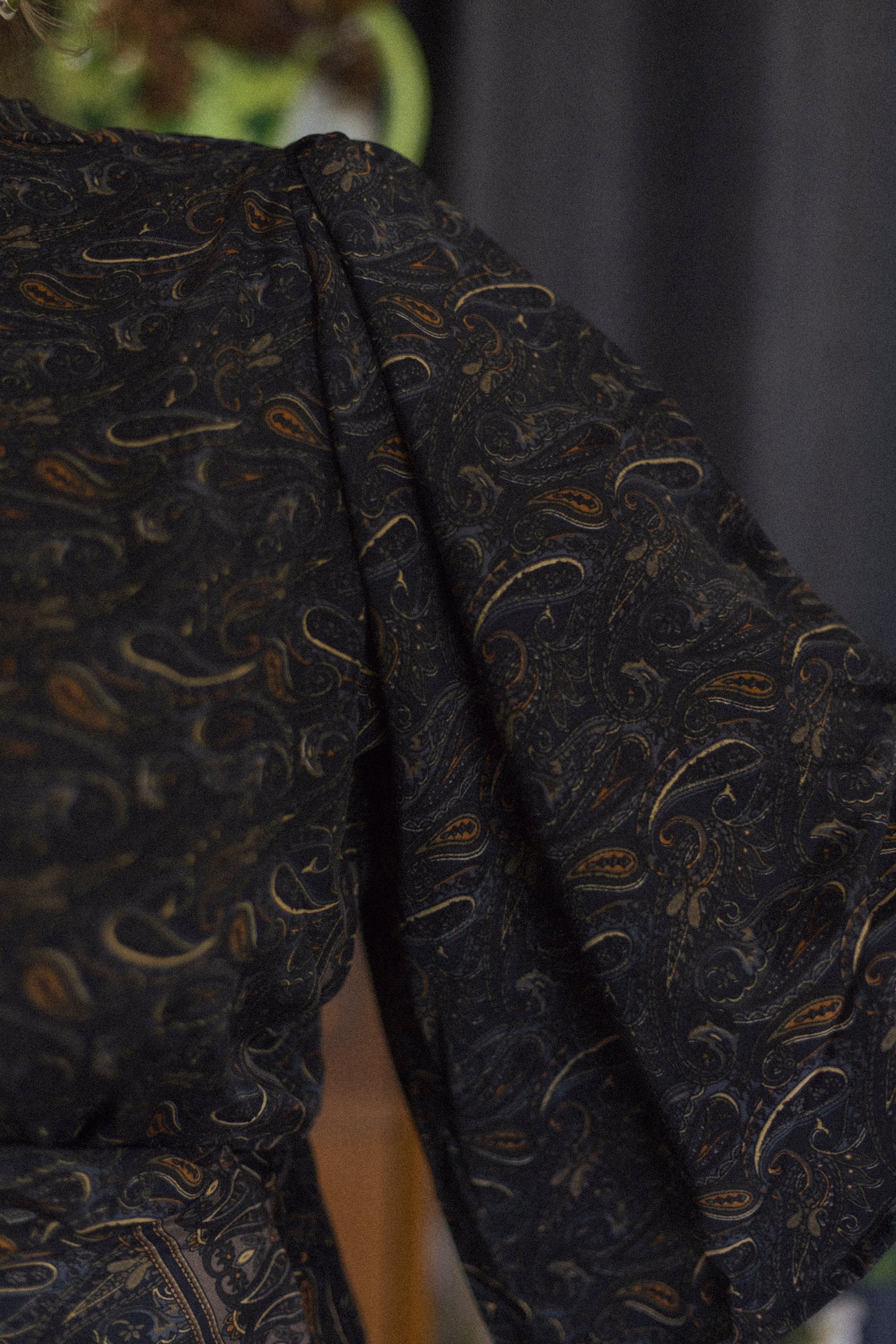 Dark fabric with a subtle pattern on a plain background