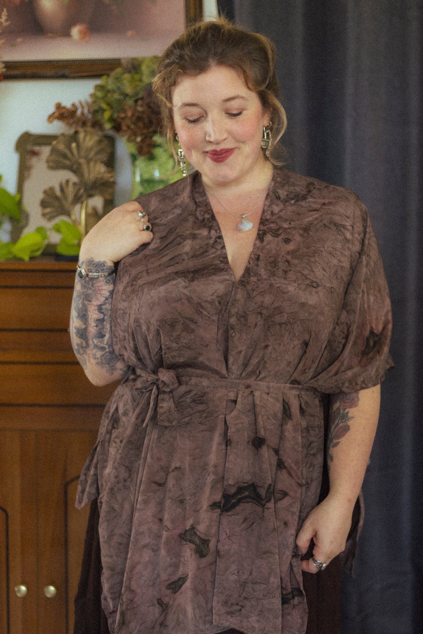 Woman wearing a brown dress with a blurred background