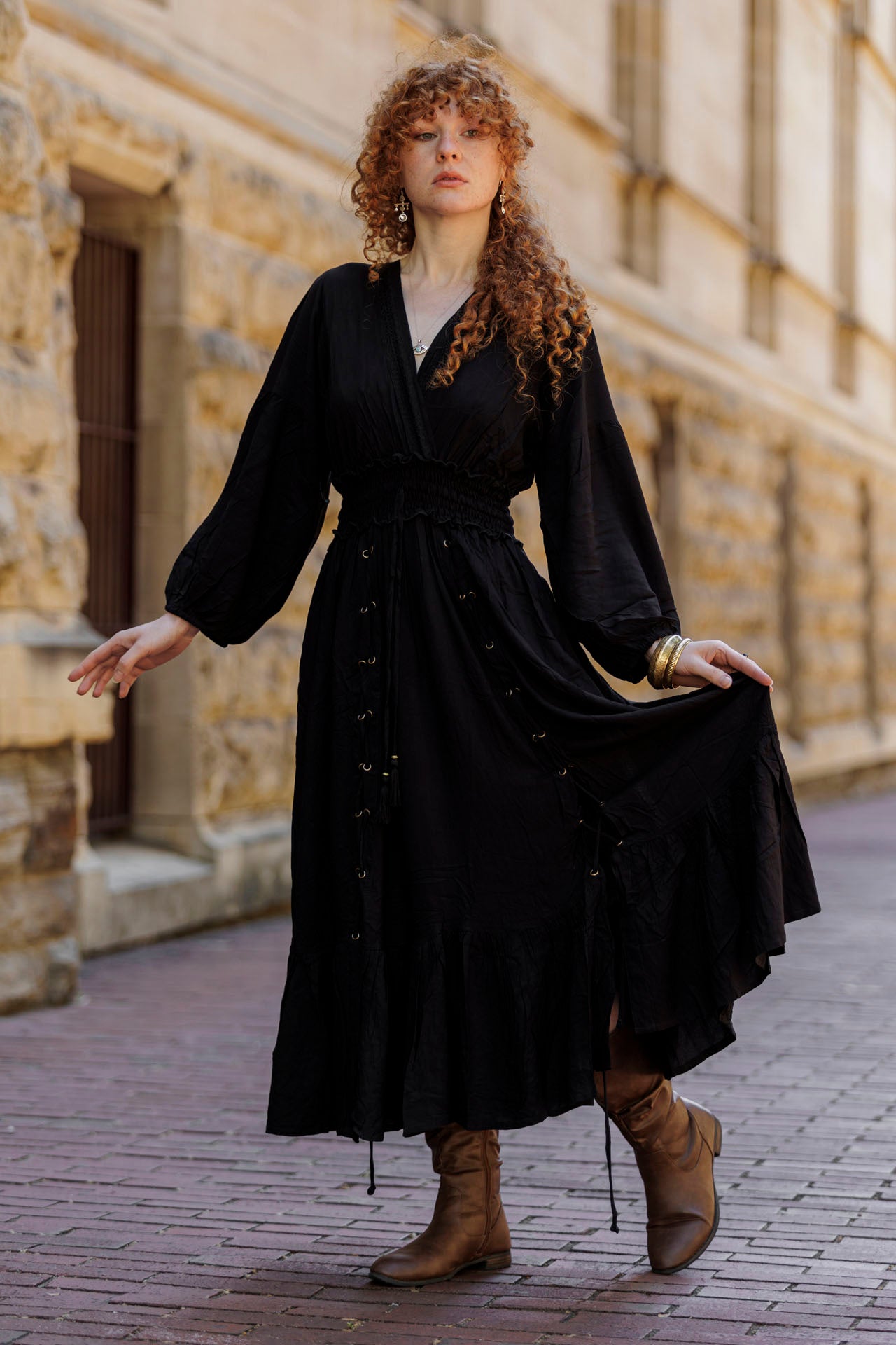 woman in a black lace up dress looking classic and refined